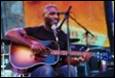 A person playing guitar and singing

Description automatically generated with medium confidence