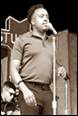 A person holding a microphone

Description automatically generated with medium confidence