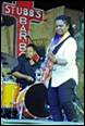 A person playing guitar on stage

Description automatically generated with low confidence