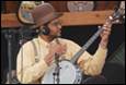 A person playing a banjo

Description automatically generated