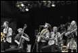 A group of people playing instruments

Description automatically generated