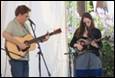 A person and person playing instruments

Description automatically generated