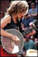 A person playing a banjo

Description automatically generated