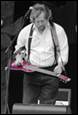 A person playing a pink guitar

Description automatically generated