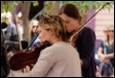 A group of women playing instruments

Description automatically generated