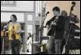 A group of people playing instruments

Description automatically generated