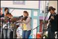 A group of people playing instruments

Description automatically generated
