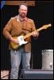 A person playing a guitar

Description automatically generated