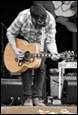 A person playing a guitar

Description automatically generated