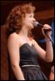 A person singing into a microphone

Description automatically generated