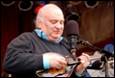 A person playing a mandolin

Description automatically generated