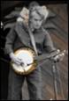 A person playing a banjo

Description automatically generated