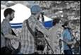 A group of people standing outside

Description automatically generated