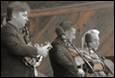 A group of men playing instruments

Description automatically generated