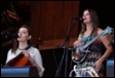 A group of women playing instruments

Description automatically generated