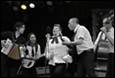 A group of people performing on stage

Description automatically generated