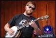 A person playing a banjo

Description automatically generated