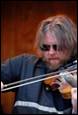 A person playing a violin

Description automatically generated