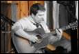 A person playing a guitar

Description automatically generated