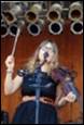 A person playing violin and a microphone

Description automatically generated