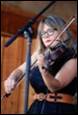 A person playing a violin

Description automatically generated