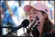 A person singing into a microphone

Description automatically generated