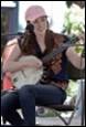 A person playing a banjo

Description automatically generated