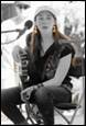 A person sitting on a chair with a guitar

Description automatically generated