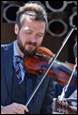 A person playing a violin

Description automatically generated
