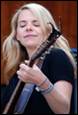 A person holding a guitar

Description automatically generated
