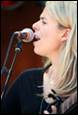 A person singing into a microphone

Description automatically generated