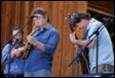 A group of men playing instruments

Description automatically generated