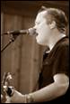 A person singing into a microphone

Description automatically generated