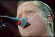 A person with a microphone in his mouth

Description automatically generated