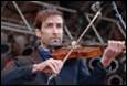A person playing a violin

Description automatically generated