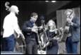 A group of people playing instruments

Description automatically generated