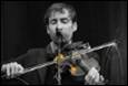 A person playing a violin

Description automatically generated