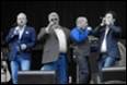 A group of men dancing on stage

Description automatically generated