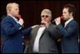 A group of men singing into microphones

Description automatically generated