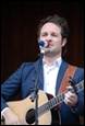 A person playing a guitar

Description automatically generated