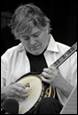 A person playing a banjo

Description automatically generated