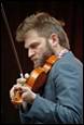 A person playing a violin

Description automatically generated