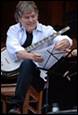 A person playing a banjo

Description automatically generated