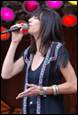 A person singing into a microphone

Description automatically generated