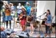 A group of people playing instruments

Description automatically generated