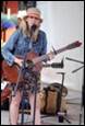 A person playing guitar and singing

Description automatically generated