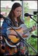 A person playing a guitar

Description automatically generated