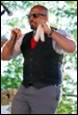A person in a vest and tie

Description automatically generated