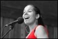 A person singing into a microphone

Description automatically generated