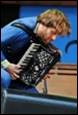 A person playing an accordion

Description automatically generated